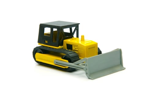 Miniature model earth moving equipment isolated against a white background