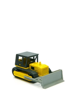 Miniature model earth moving equipment isolated against a white background