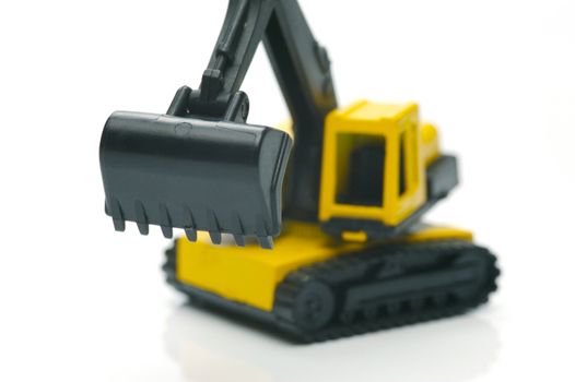 Miniature model earth moving equipment isolated against a white background