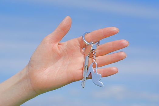 Hand with a key against the sky