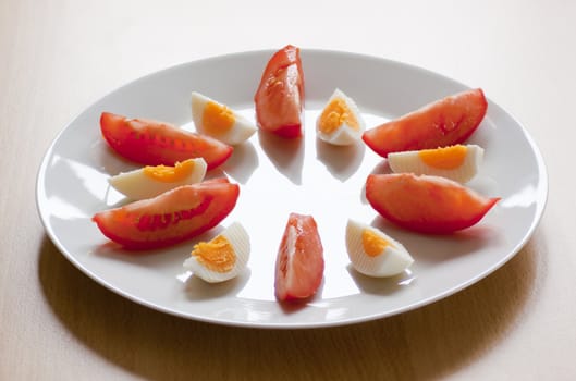 Cut tomatoes and an egg on a plate