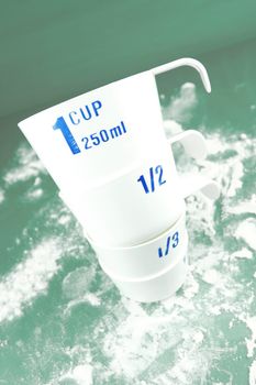 Measuring cups isolated against a green backgroundd