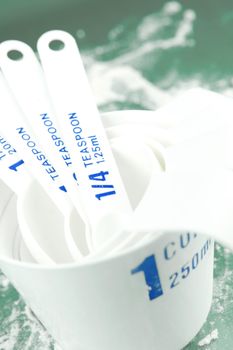 Measuring cups isolated against a green backgroundd