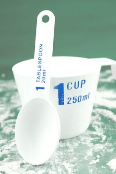 Measuring cups isolated against a green backgroundd