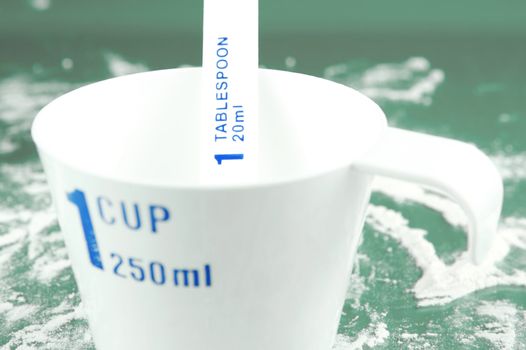 Measuring cups isolated against a green backgroundd