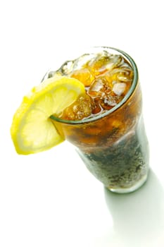 A glass of lemon cola isolated against a white background