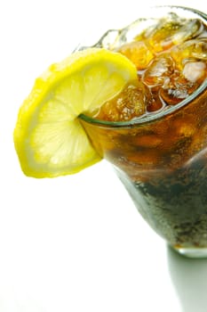 A glass of lemon cola isolated against a white background