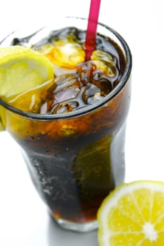 A glass of lemon cola isolated against a white background