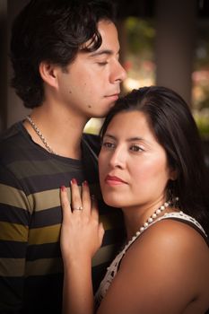 Attractive Hispanic Couple Portrait Enjoying Each Other Outdoors.