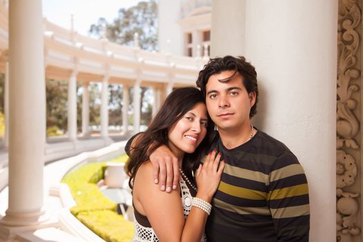 Attractive Hispanic Couple Portrait Enjoying Each Other Outdoors.