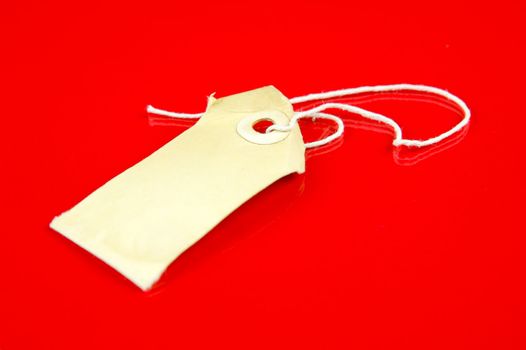 A price tag isolated against a red background