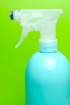 A spray bottle isolated against a blue background