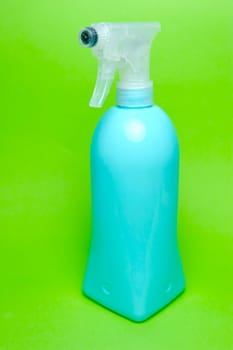 A spray bottle isolated against a blue background