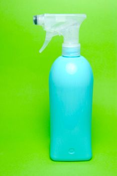 A spray bottle isolated against a blue background