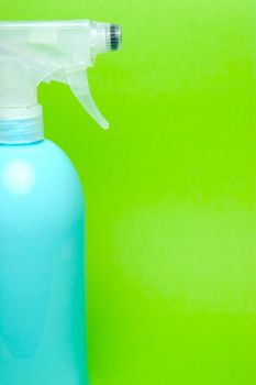 A spray bottle isolated against a blue background