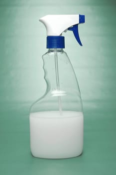 Cleaning products isolated against a green background