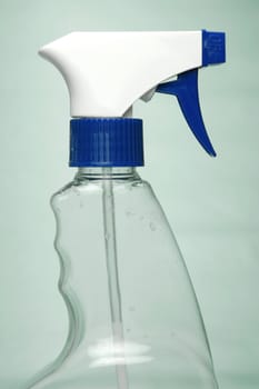 Cleaning products isolated against a green background