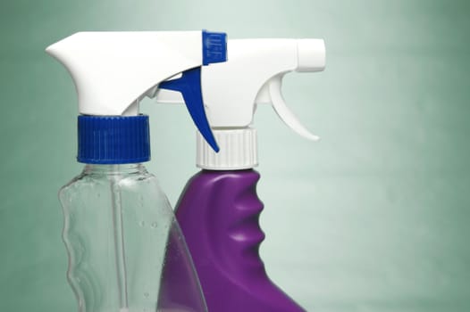 Cleaning products isolated against a green background