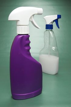 Cleaning products isolated against a green background