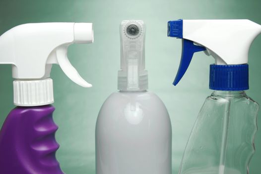 Cleaning products isolated against a green background