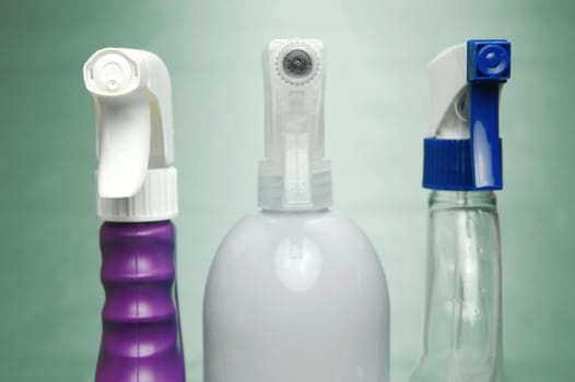 Cleaning products isolated against a green background