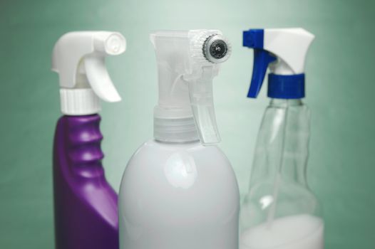 Cleaning products isolated against a green background