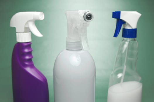 Cleaning products isolated against a green background