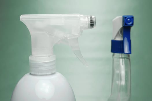 Cleaning products isolated against a green background