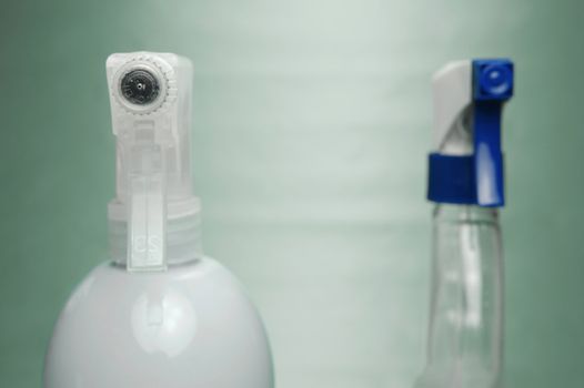 Cleaning products isolated against a green background