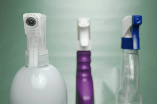 Cleaning products isolated against a green background