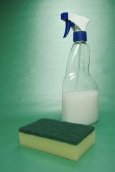 Cleaning products isolated against a green background