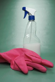 Cleaning products isolated against a green background