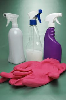 Cleaning products isolated against a green background