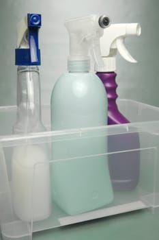 Cleaning products isolated against a green background