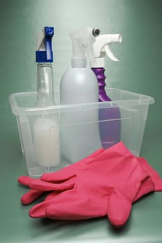 Cleaning products isolated against a green background