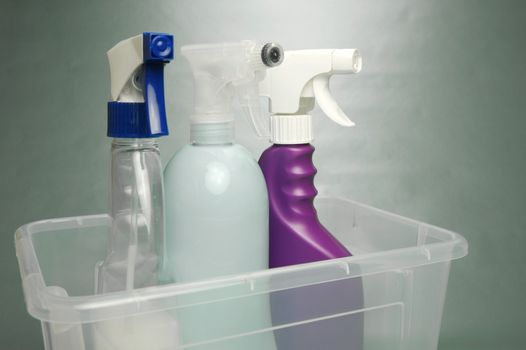 Cleaning products isolated against a green background