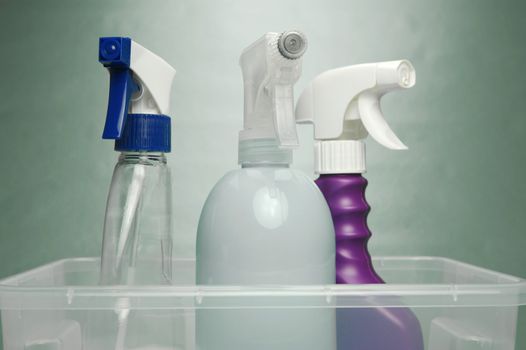 Cleaning products isolated against a green background