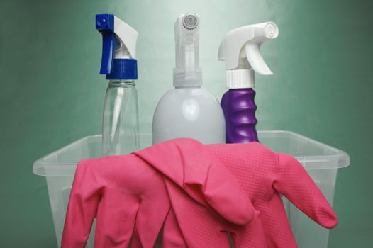 Cleaning products isolated against a green background