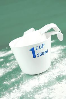 Measuring cups isolated against a green background