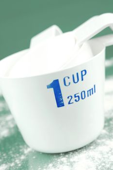 Measuring cups isolated against a green background