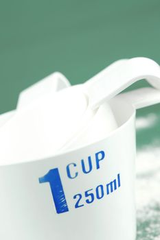 Measuring cups isolated against a green background