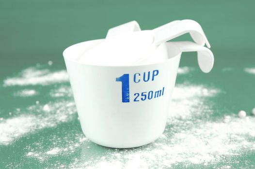 Measuring cups isolated against a green background