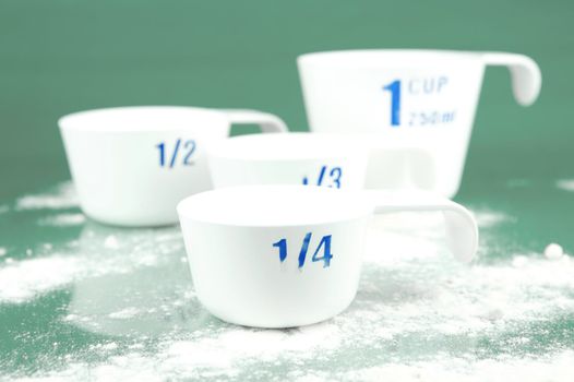 Measuring cups isolated against a green background