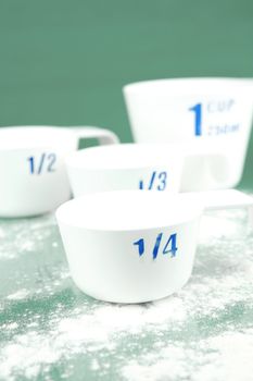 Measuring cups isolated against a green background