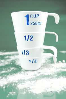 Measuring cups isolated against a green background