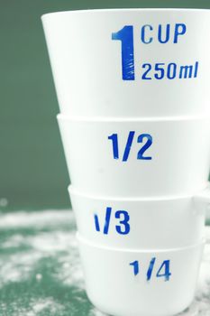 Measuring cups isolated against a green background