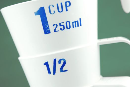 Measuring cups isolated against a green background