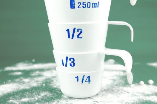 Measuring cups isolated against a green background