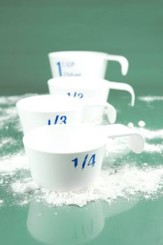 Measuring cups isolated against a green background