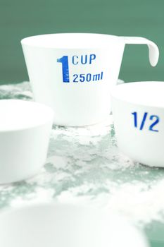 Measuring cups isolated against a green background